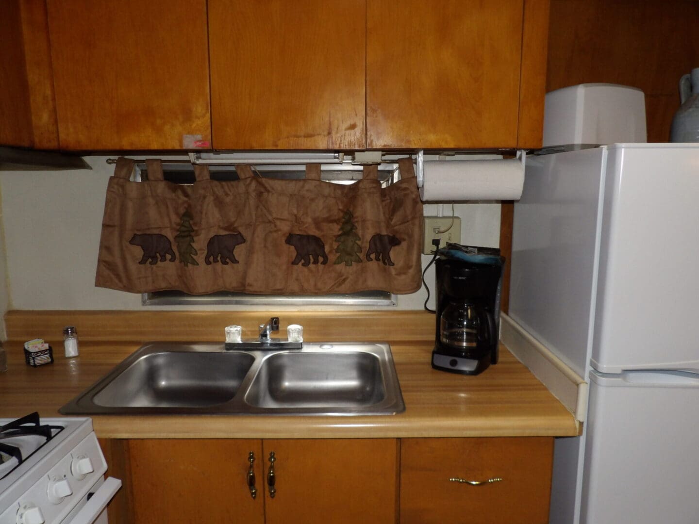 A kitchen with two sinks and a coffee maker.