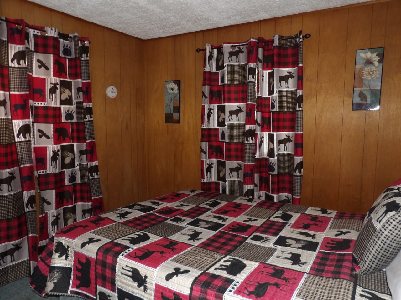 A bedroom with a bed and curtains in it