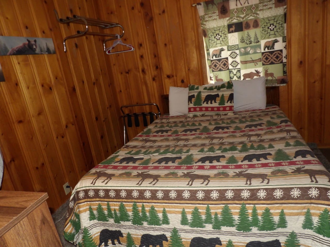 A bed with a bear print blanket on it