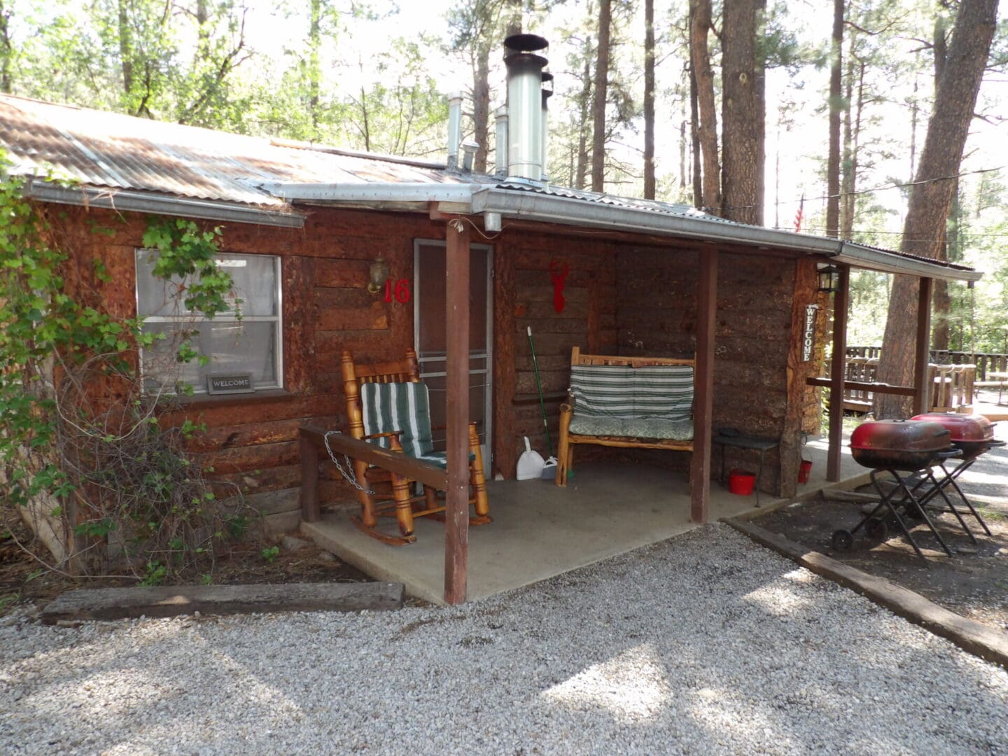entrance to a cabin with chairs and grills